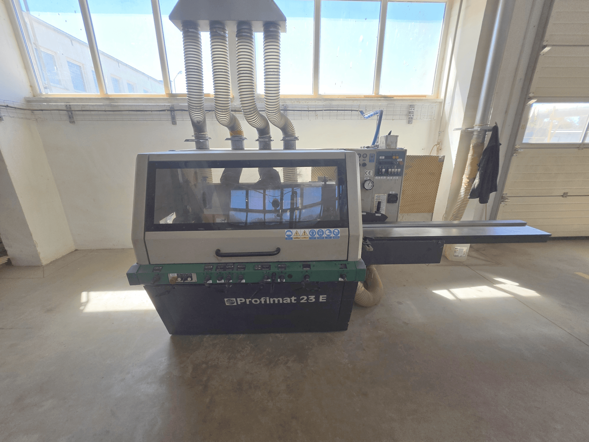 WEINIG DIMTER PROFIMAT 23 E houtschaafmachine, vooraanzicht, voorzien van bedieningspaneel, invoertafel en stofafzuigslangen.