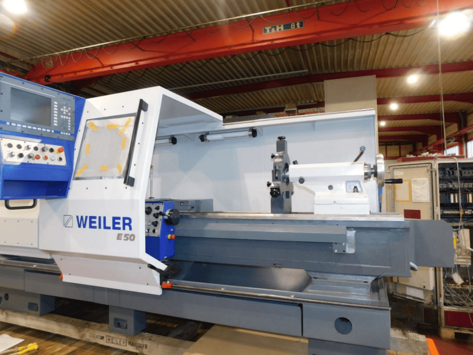 Weiler E50 horizontale draaimachine, vooraanzicht, met bedieningspaneel, spindel en precisiebed met accessoires.