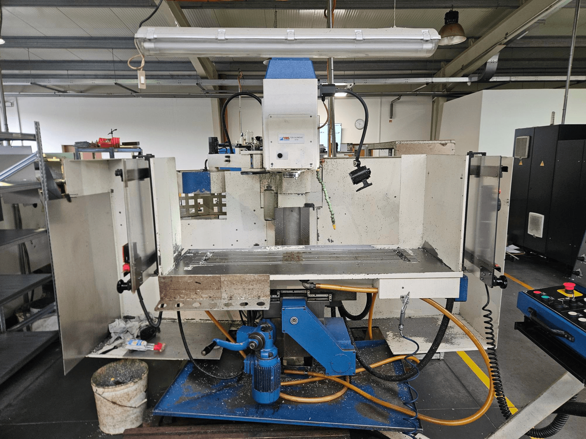 TOS Olomouc FV30 CNC Een verticaal bewerkingscentrum in een werkplaats, vooraanzicht met bedieningspaneel, werktafel en koelsysteem.