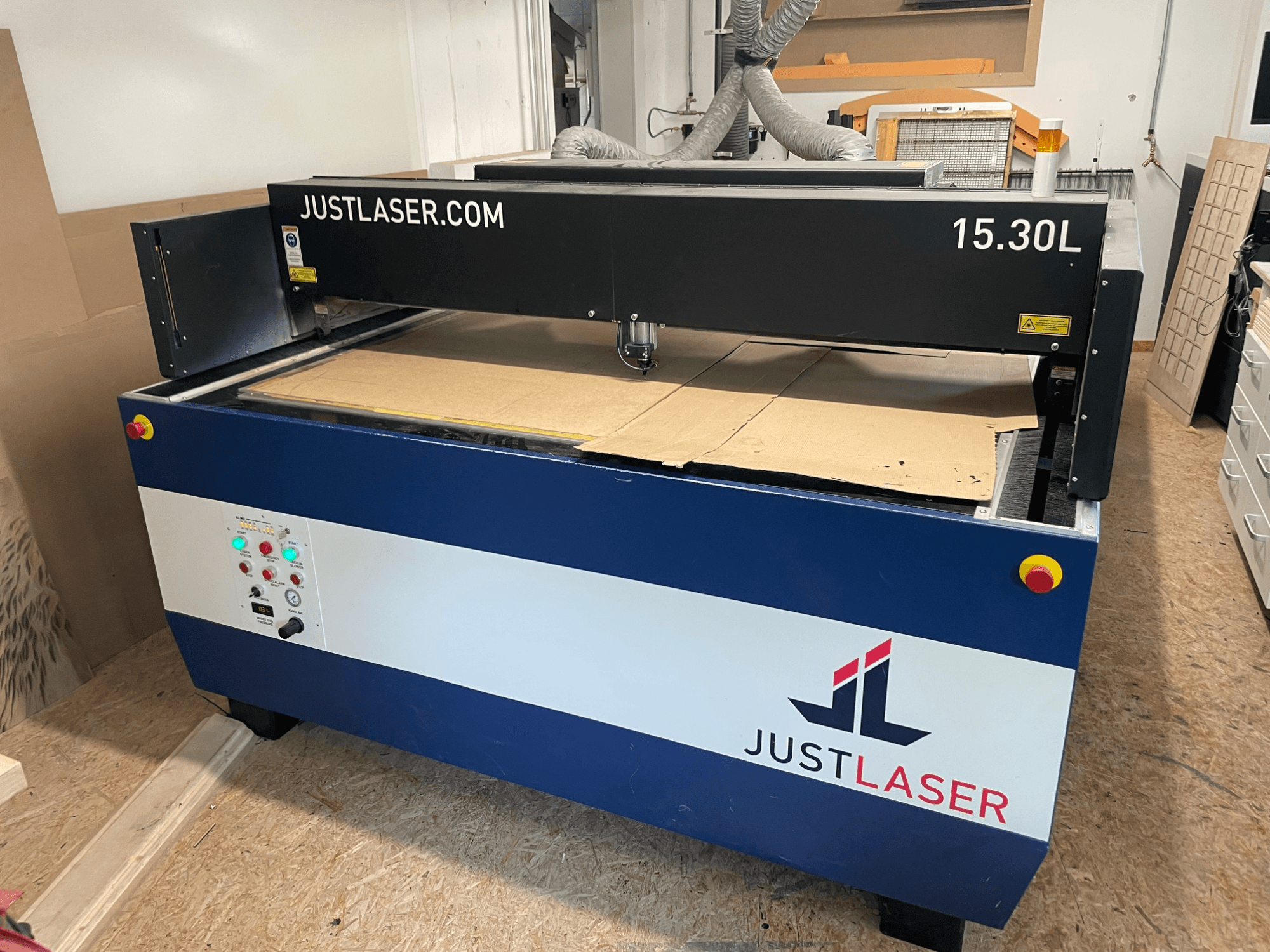 CO₂-lasersnijmachine van KERN, model KER60120-KT500 OPF, vooraanzicht met bedieningselementen en snijgebied met karton.