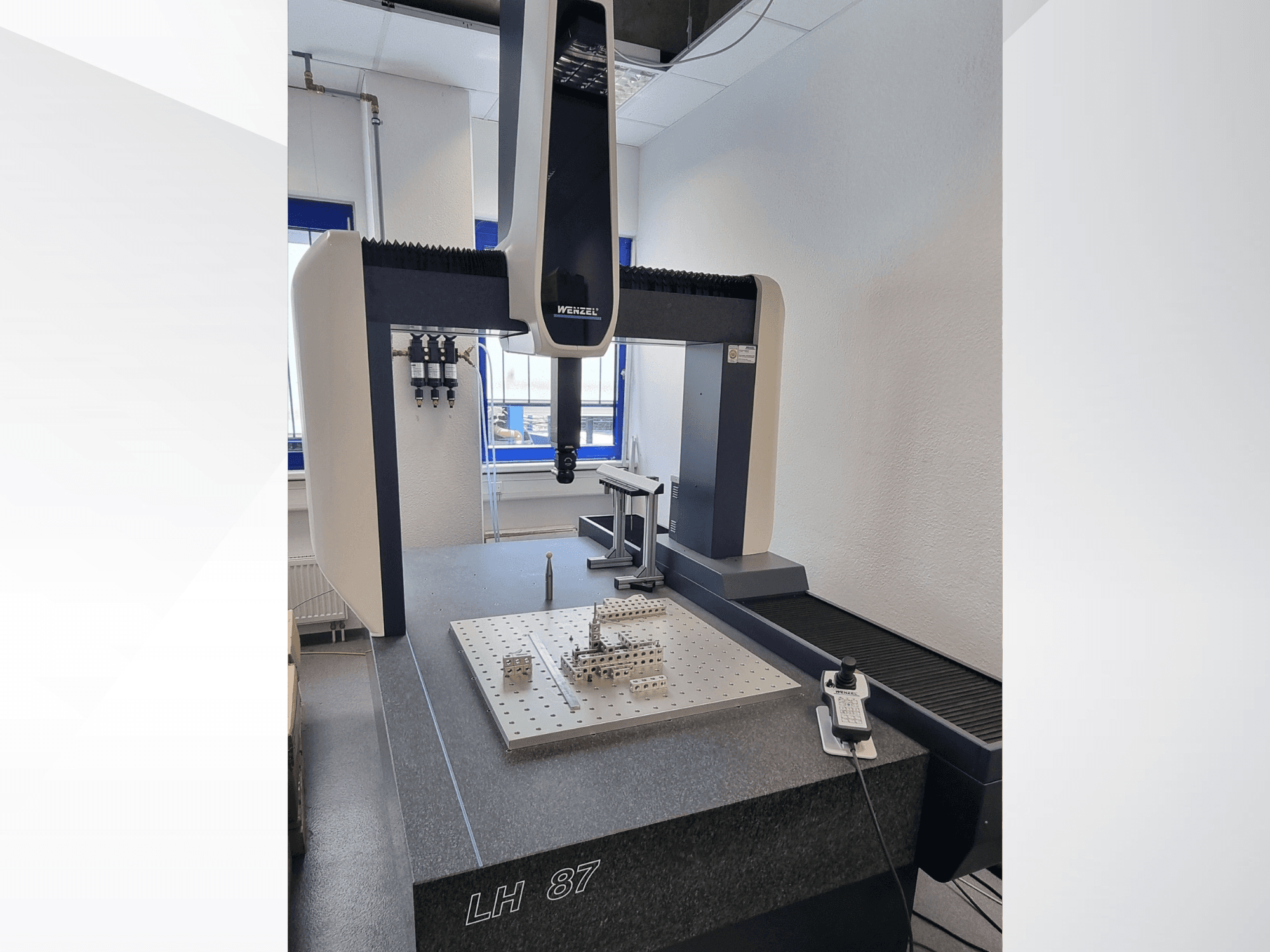 Wenzel LH 87 CMM in een laboratorium, vooraanzicht met meetsonde boven een precisie-meetplaat en zichtbare digitale besturingseenheid.