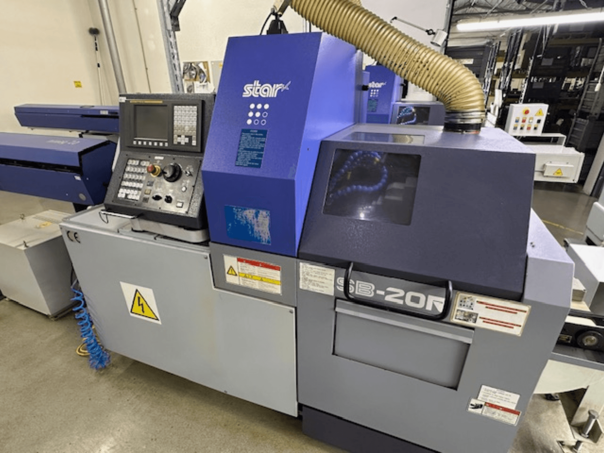 Star SB-20R type N Zwitserse draaimachine, vooraanzicht, met bedieningspaneel, zuigslang en zichtbare gevarensymbolen.