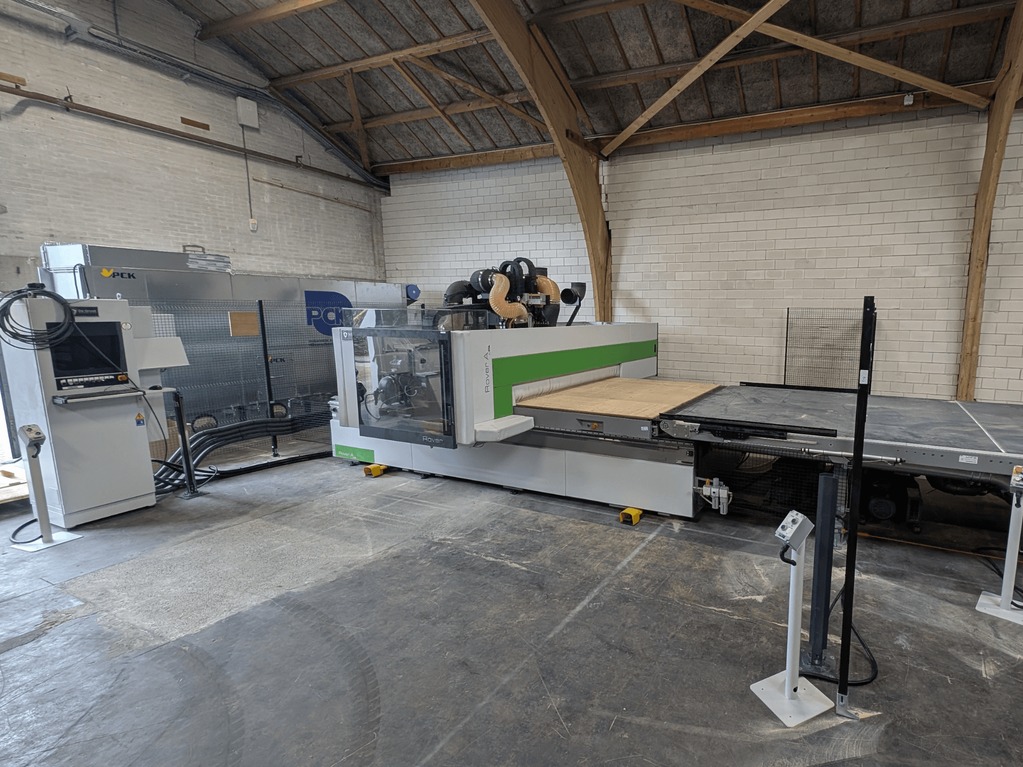 PCK CNC bewerkingscentrum, vooraanzicht, heeft een groot snijbed, bedieningspaneel, stofafzuigsysteem en een robuust ontwerp.