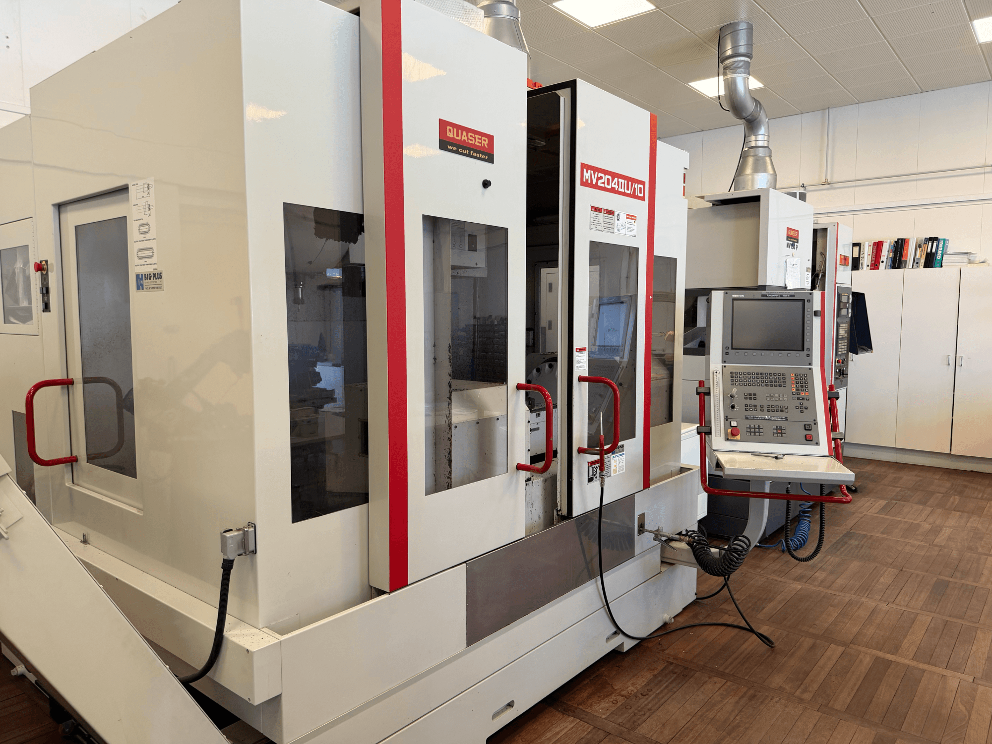 Vooraanzicht van een Quaser MV204U/10 Universeel Bewerkingscentrum, met het bedieningspaneel en de dubbele machineopstelling.