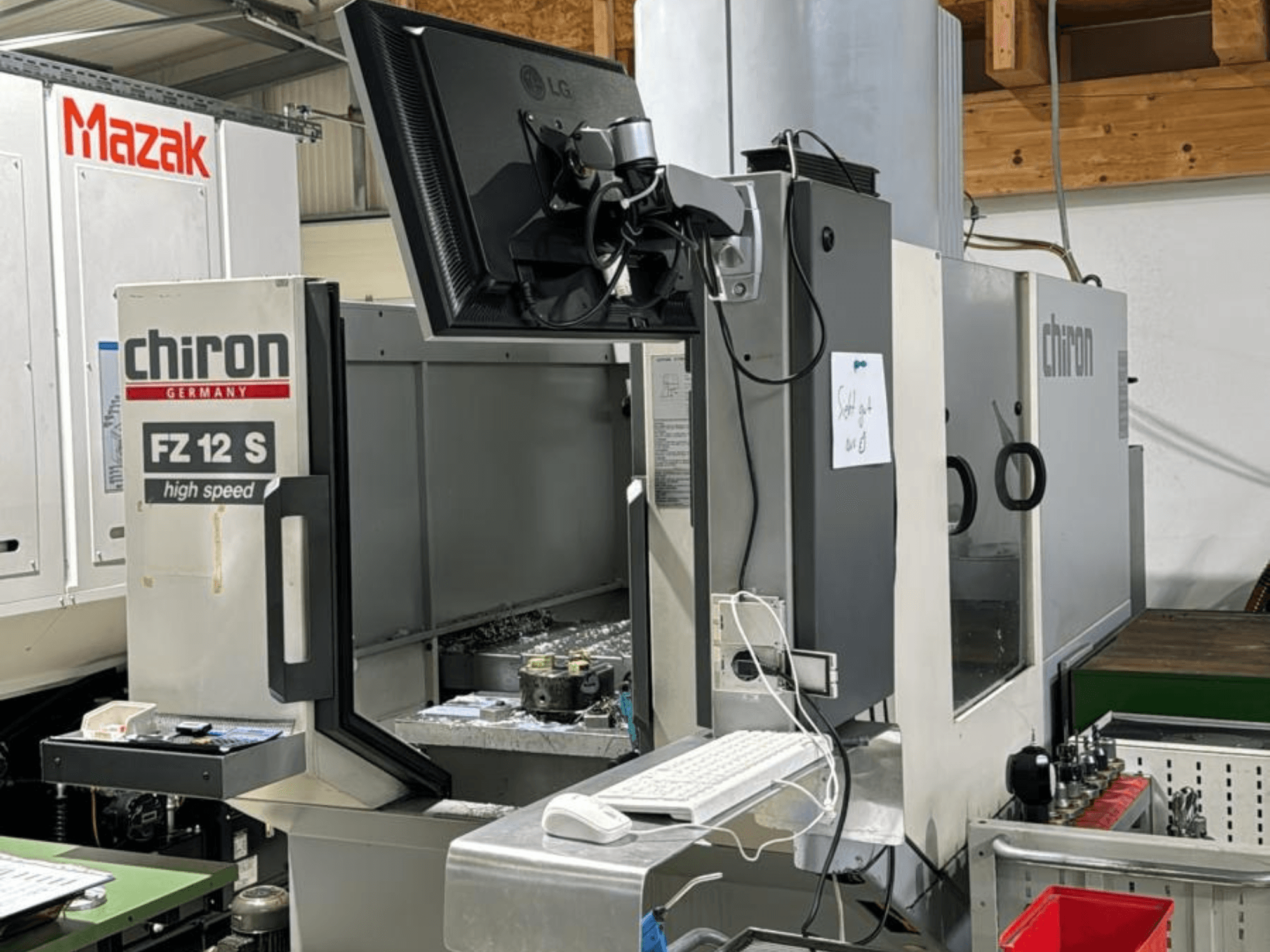 Verticaal zicht van het CHIRON FZ 12 S hogesnelheidsbewerkingscentrum met bedieningsscherm en afval van het bewerkingsproces.