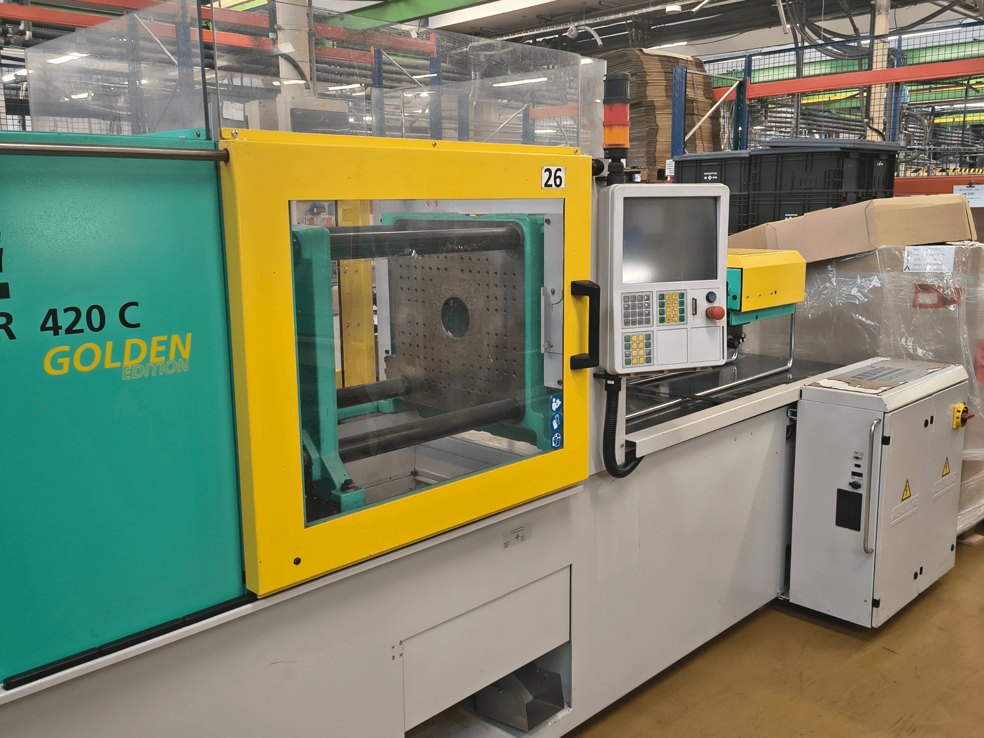 Spuitgietmachine, ARBURG 420 C Golden Edition, vooraanzicht; voorzien van bedieningspaneel, duidelijke veiligheidsafscherming en omringende werkruimte.