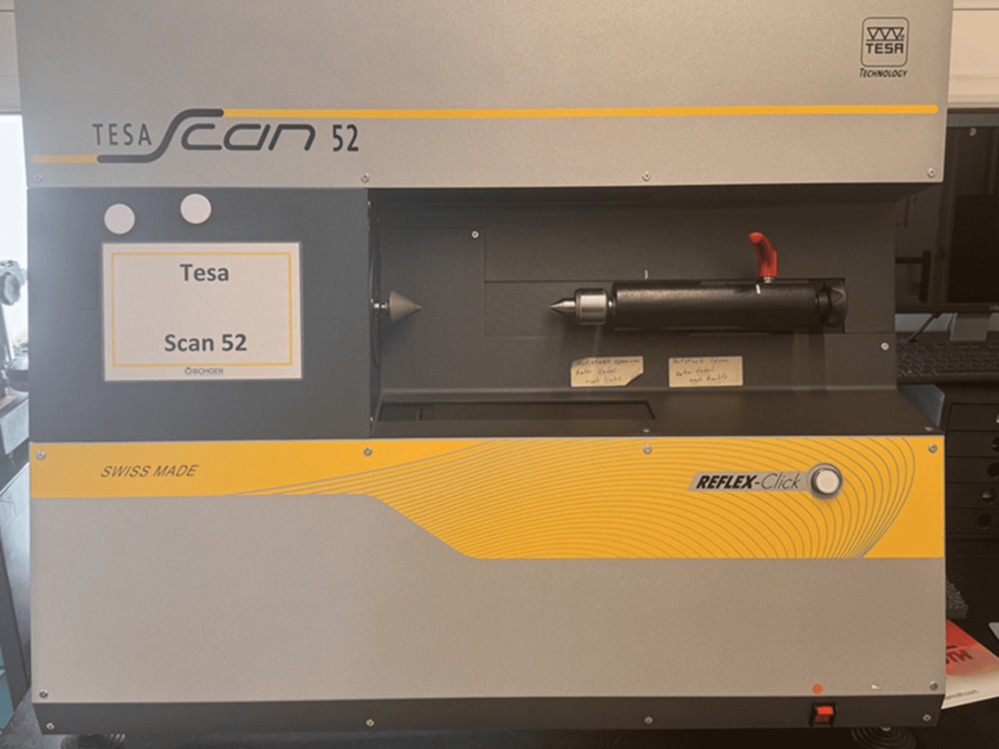 Vooraanzicht van de optische meetmachine TESA Scan 52, waarbij de bedieningsknoppen en het label „SWISS MADE“ zichtbaar zijn.