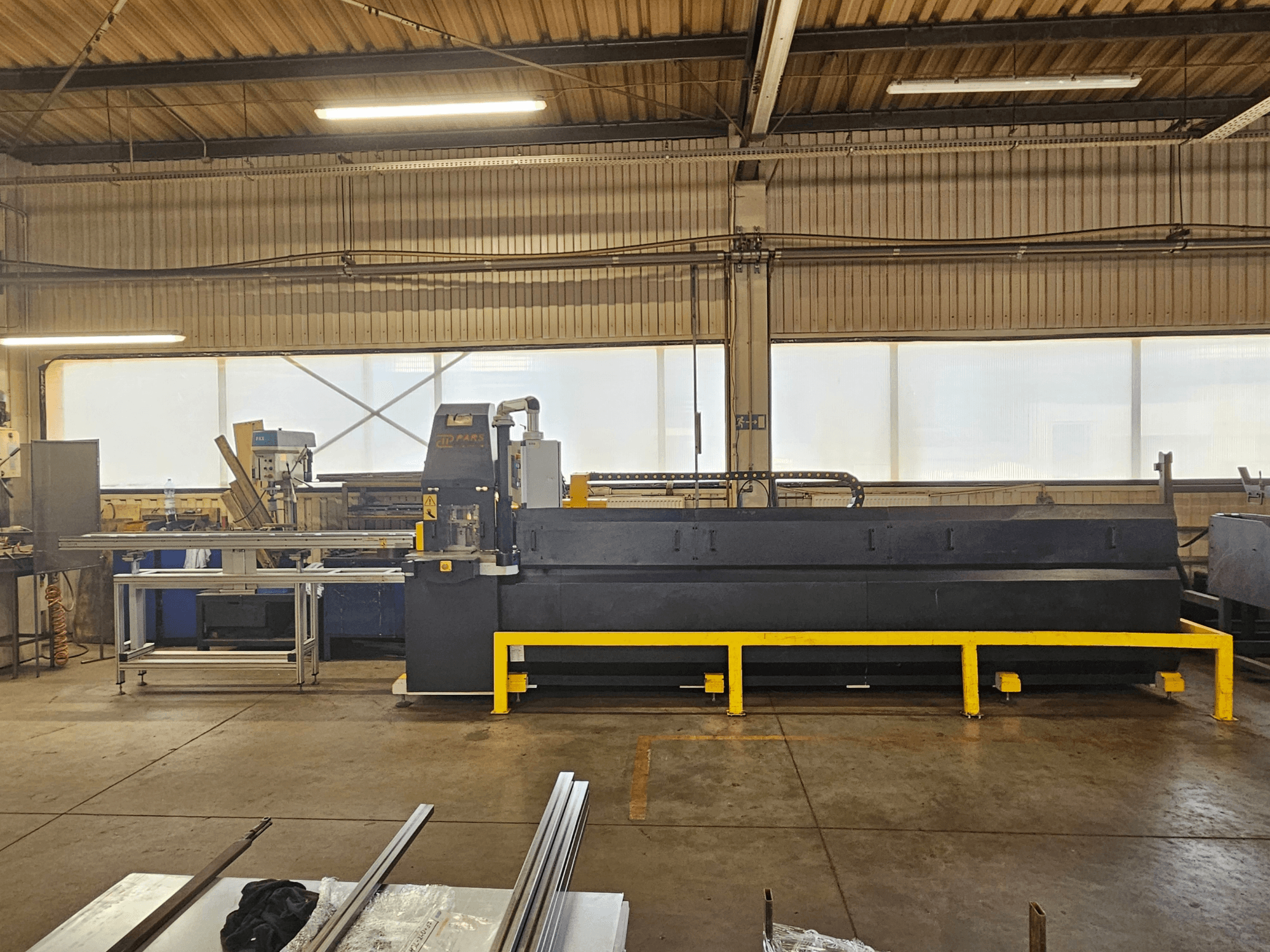 CNC-ponsmachine PARS HMP SIRIUS PLUS-3000/3-L1, vooraanzicht in een industriële omgeving met metalen oppervlakken en gereedschap.