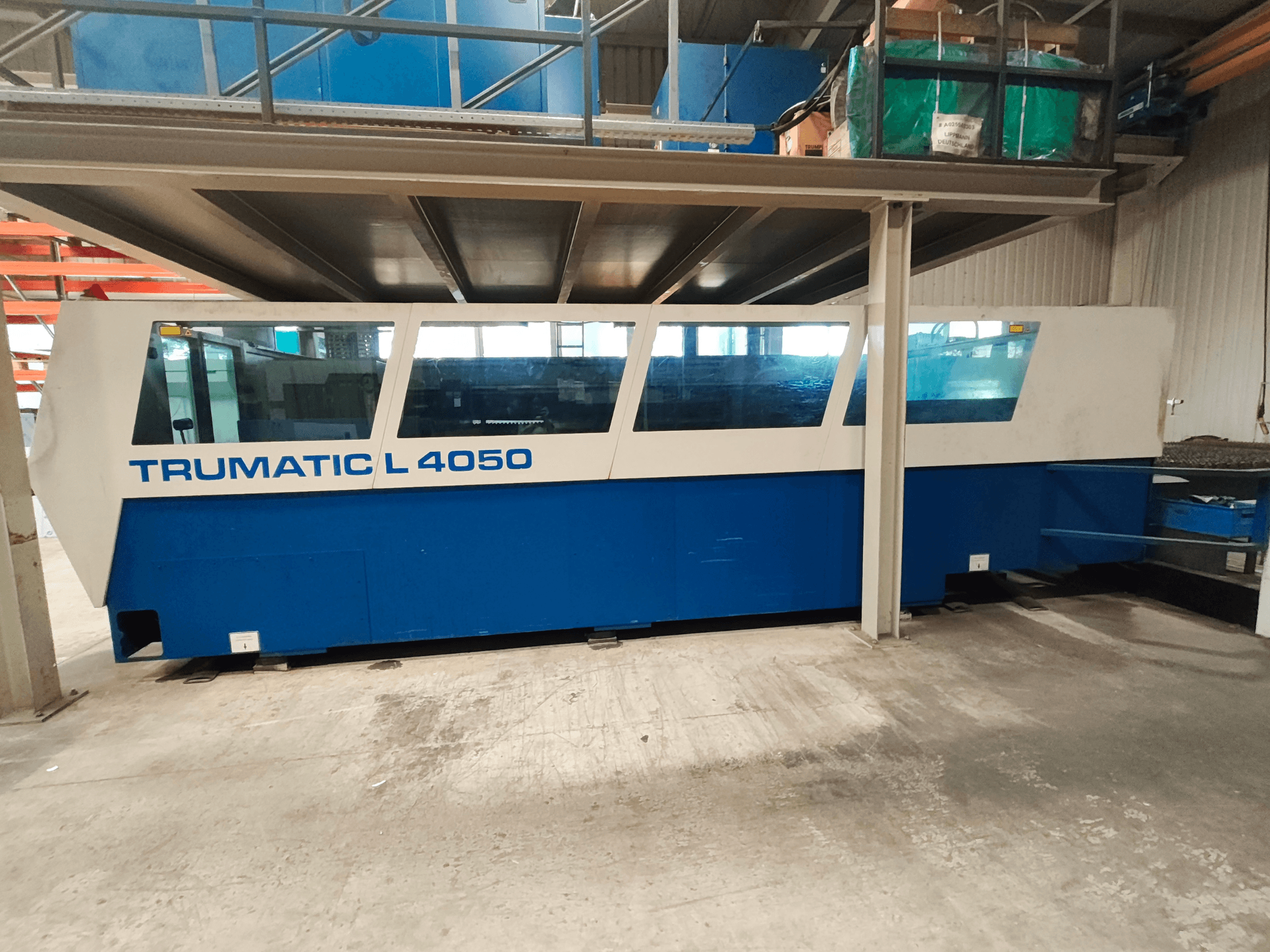 CO₂-lasersnijmachine TRUMPF TruLaser 450 in zijaanzicht, uitgevoerd in blauw en wit, met zichtbaar bedieningspaneel en werkruimte.