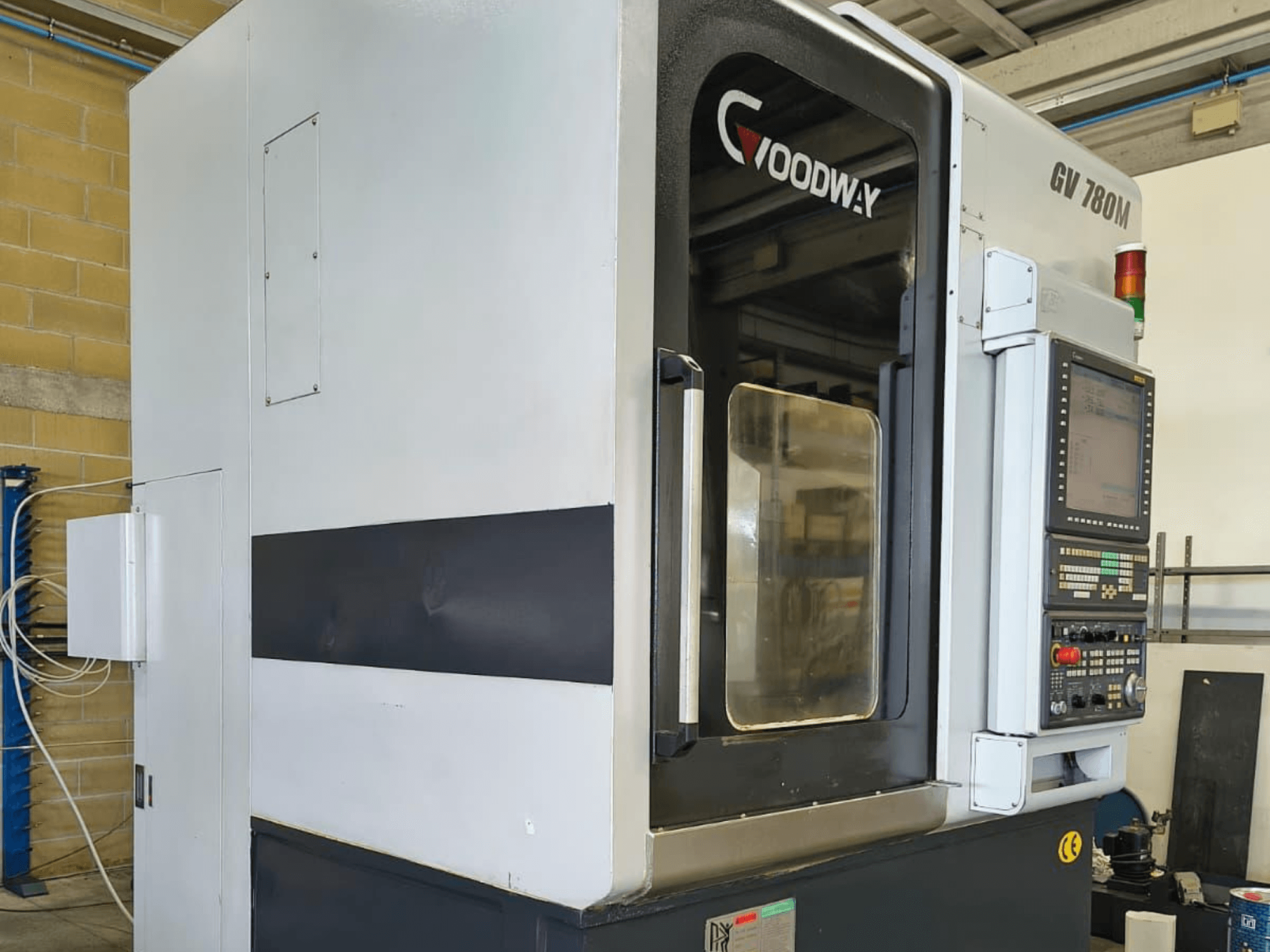 Goodway GV 780 M verticale draaimachine, zijaanzicht, met het bedieningspaneel, de veiligheidsfuncties en het strakke ontwerp van de buitenkant.