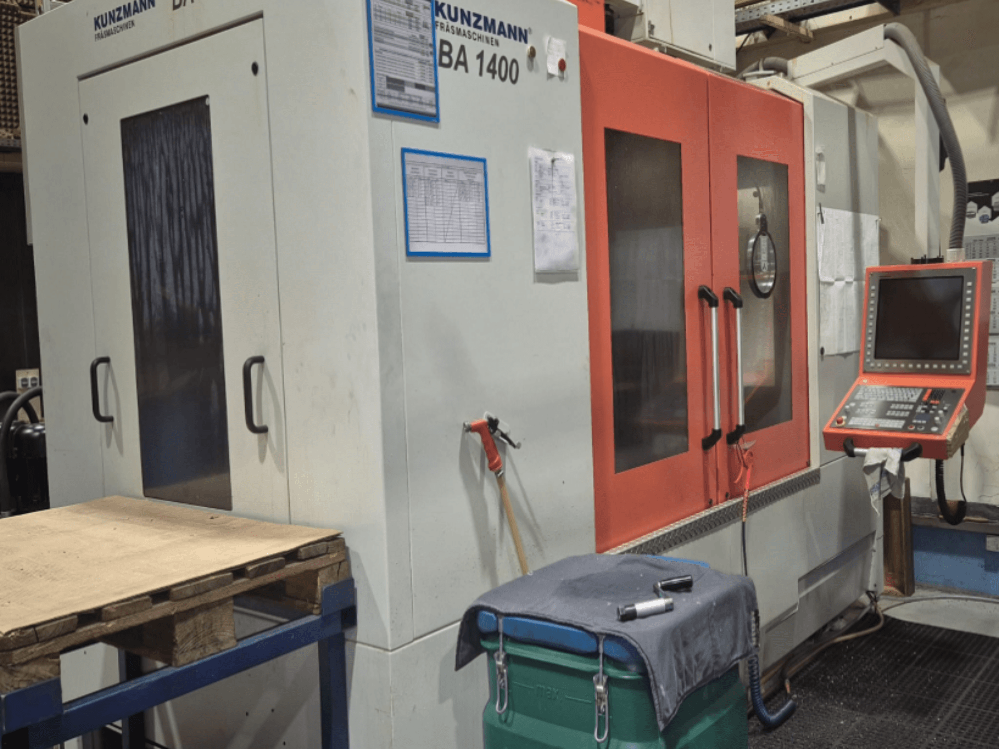 KUNZMANN BA1400 verticaal bewerkingscentrum vooraanzicht, met oranje deuren, bedieningspaneel en werktafel.