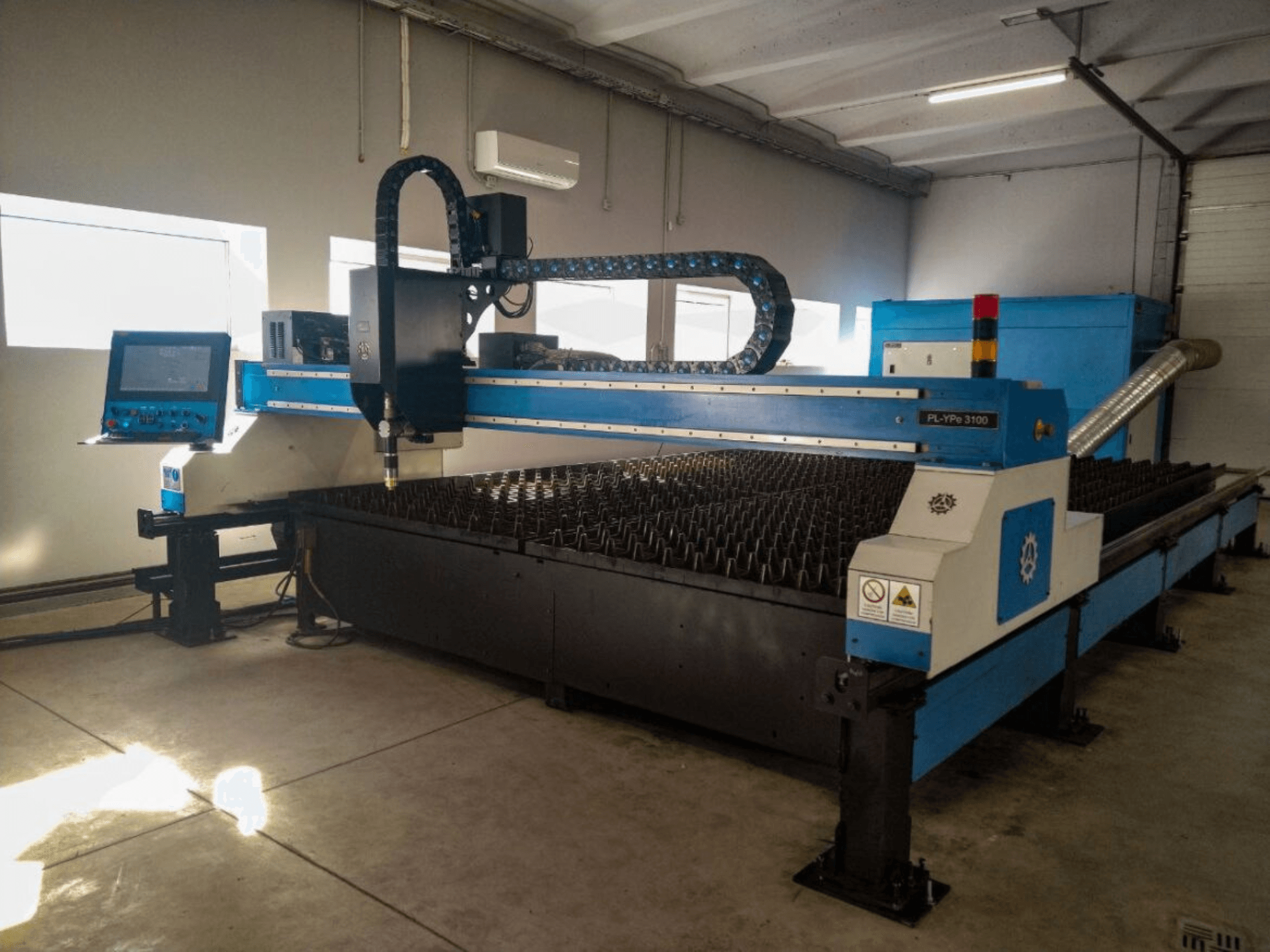 PL-YP© 3100 CNC snijmachine met display, vooraanzicht, met een metalen snijbed en precieze spuitmondgeleiding.