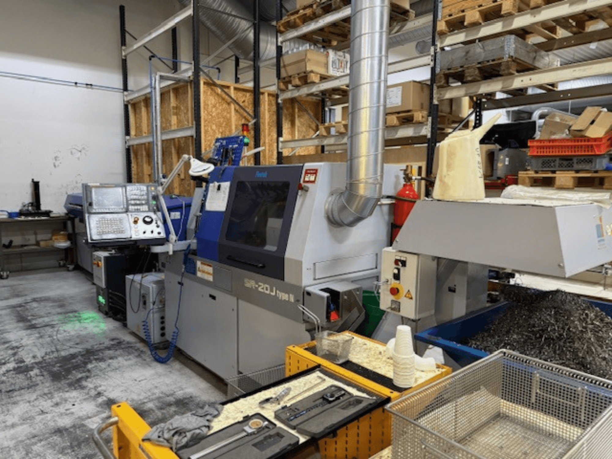 Vooraanzicht van een Faroh SPR-20J type N bewerkingscentrum met bedieningspaneel, metaalschilfers en veiligheidsapparatuur in een werkplaats.