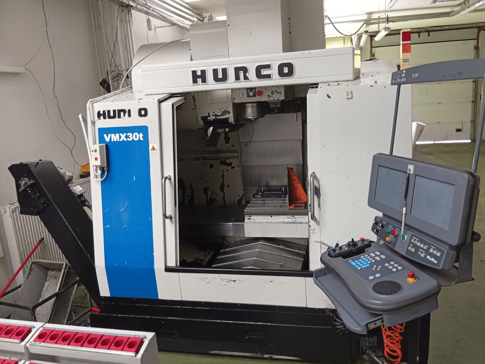 Hurco VMX 30T verticaal bewerkingscentrum, vooraanzicht, met bedieningspaneel en spilgedeelte, waarbij de werktafel zichtbaar is.