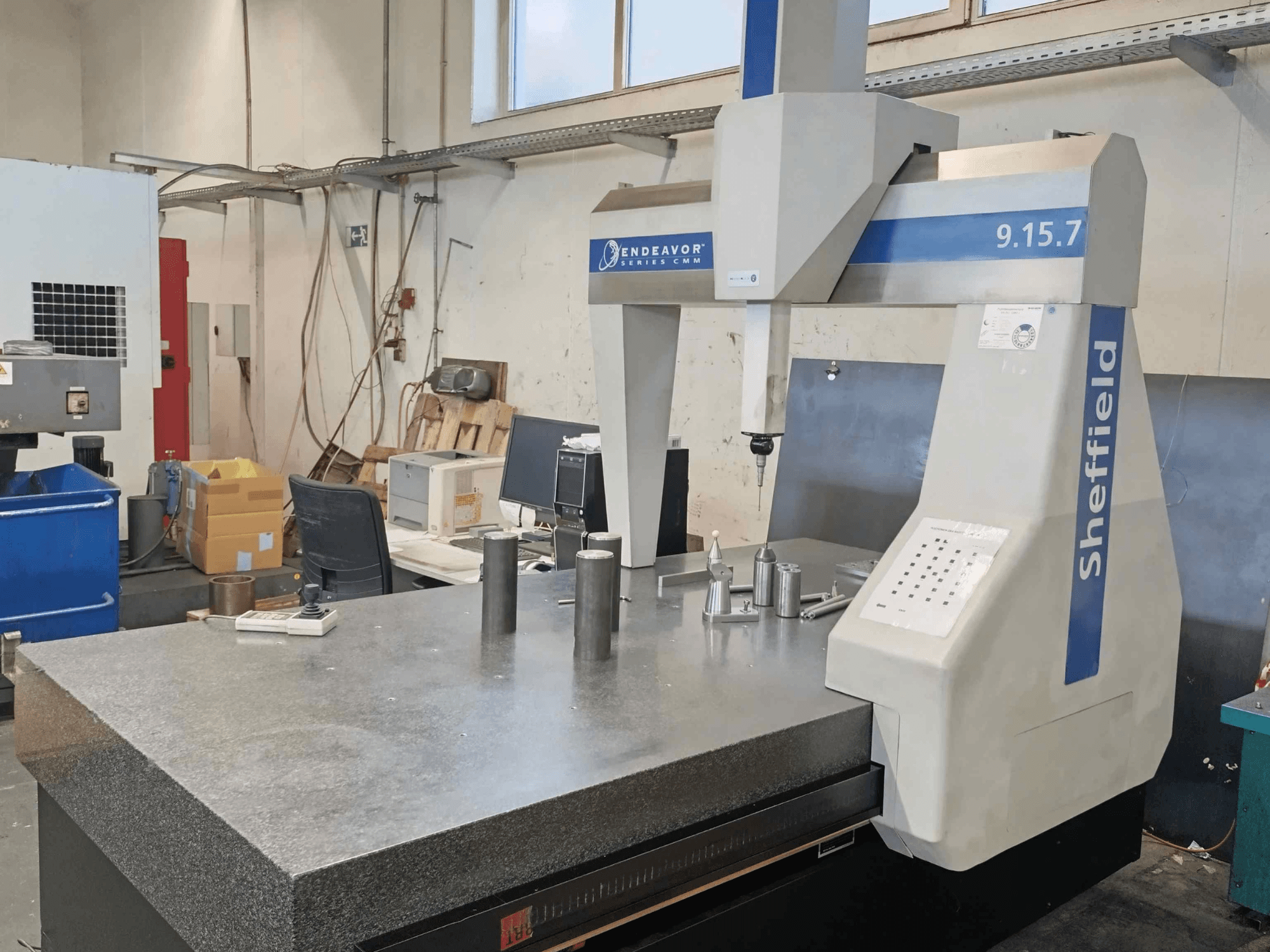 Coördinatenmeetmachine Sheffield Endeavor 9.15.7 in een werkplaats, met een granieten tafel en metalen werkstukken.
