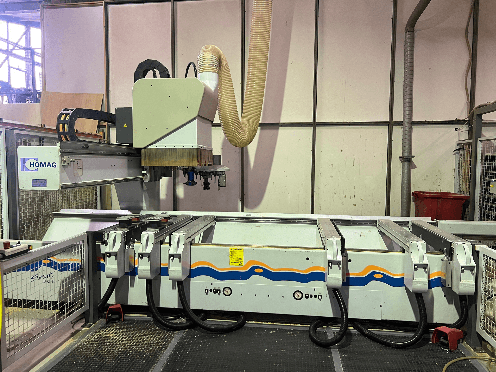 HOMAG BIZ 4 CNC machine in werkplaats; vooraanzicht met stofafzuigsysteem en bedieningspaneel met kabels.