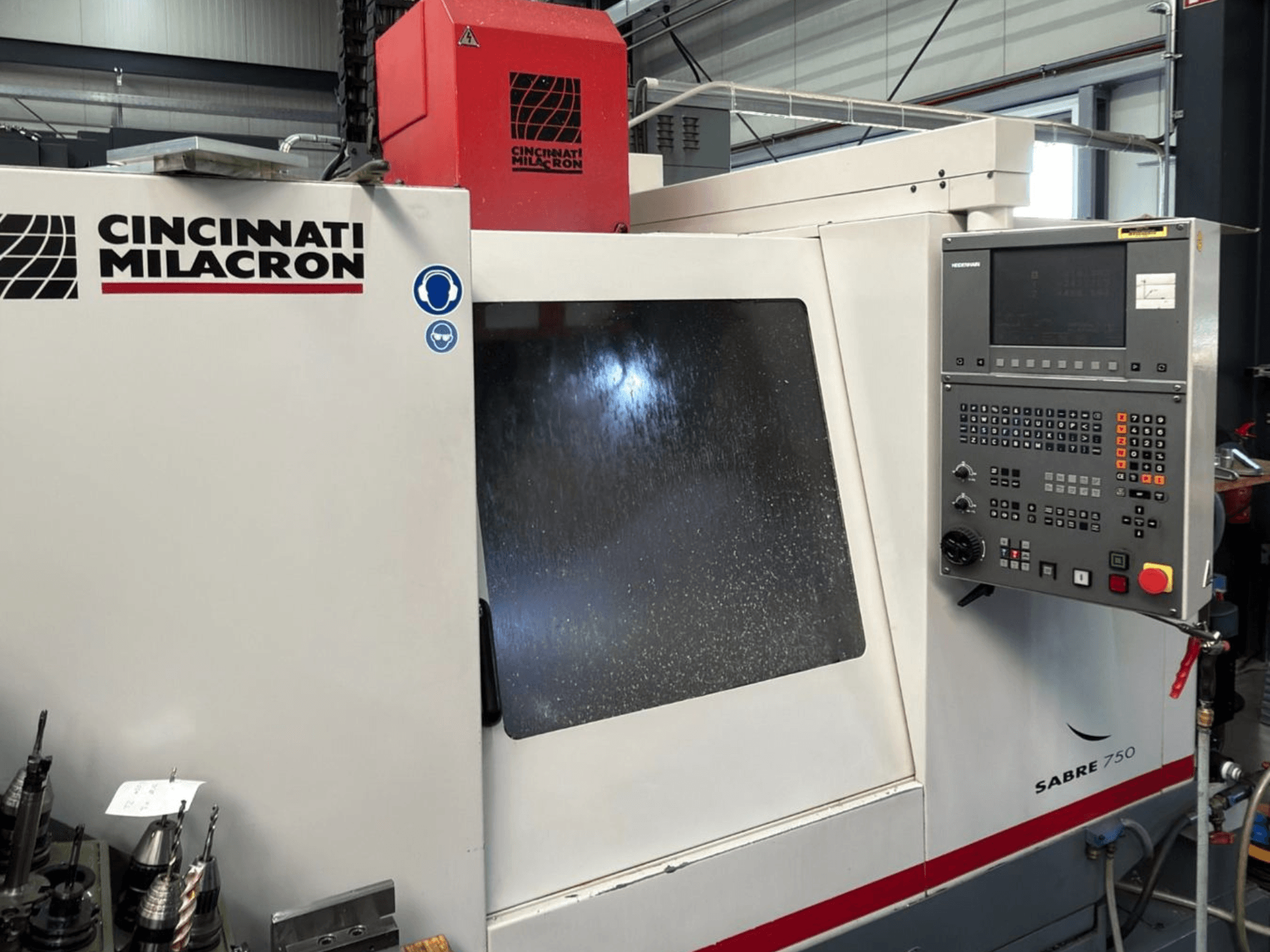 Cincinnati Milacron Sabre 750 verticaal bewerkingscentrum, vooraanzicht, met bedieningspaneel en gedeeltelijk ondoorzichtig glas.
