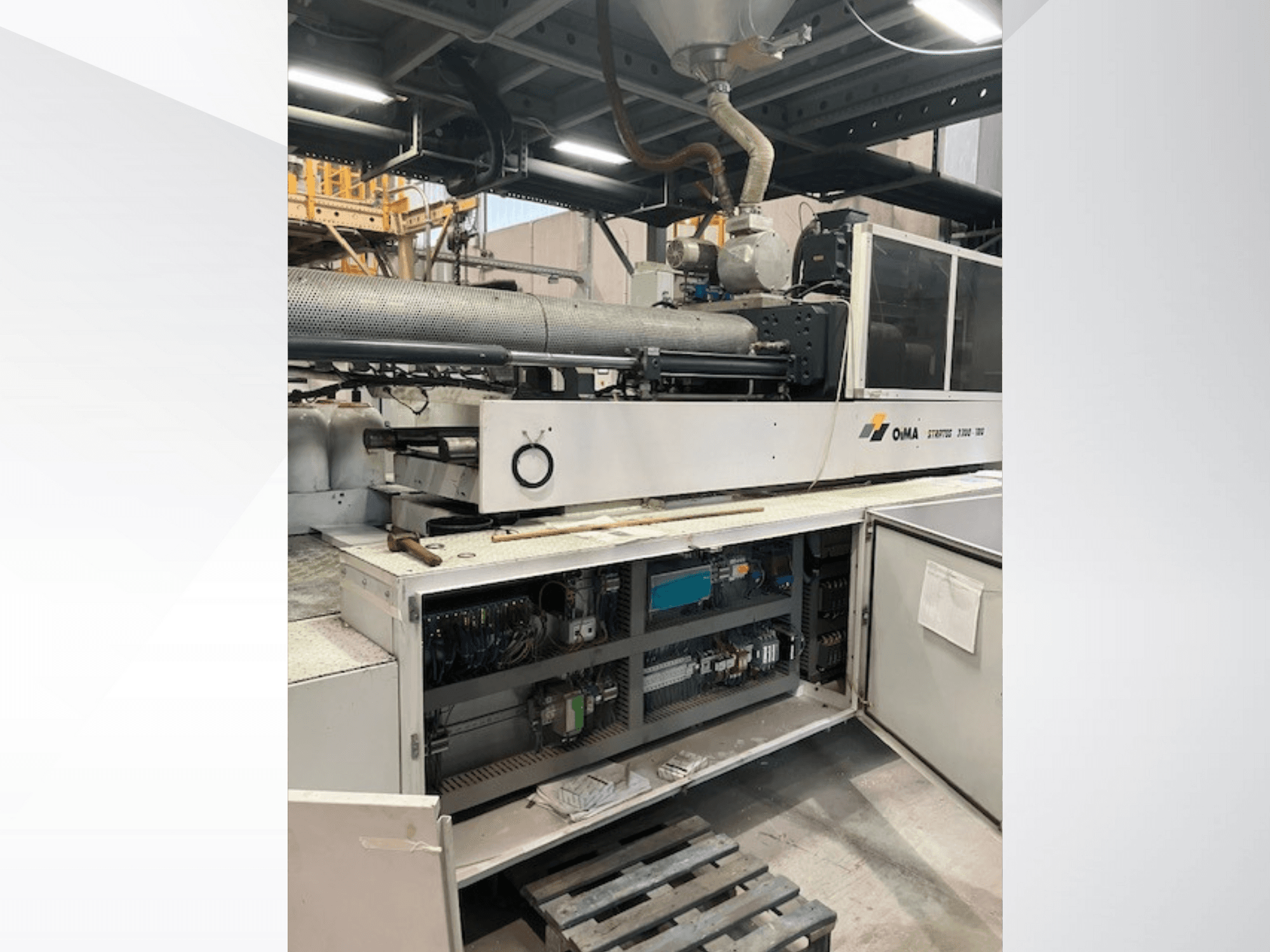 Vooraanzicht van de OMA Extruder 3500, met operationele onderdelen, bedieningspaneel en bedradingsdetails. Zware machines in een industriële omgeving.