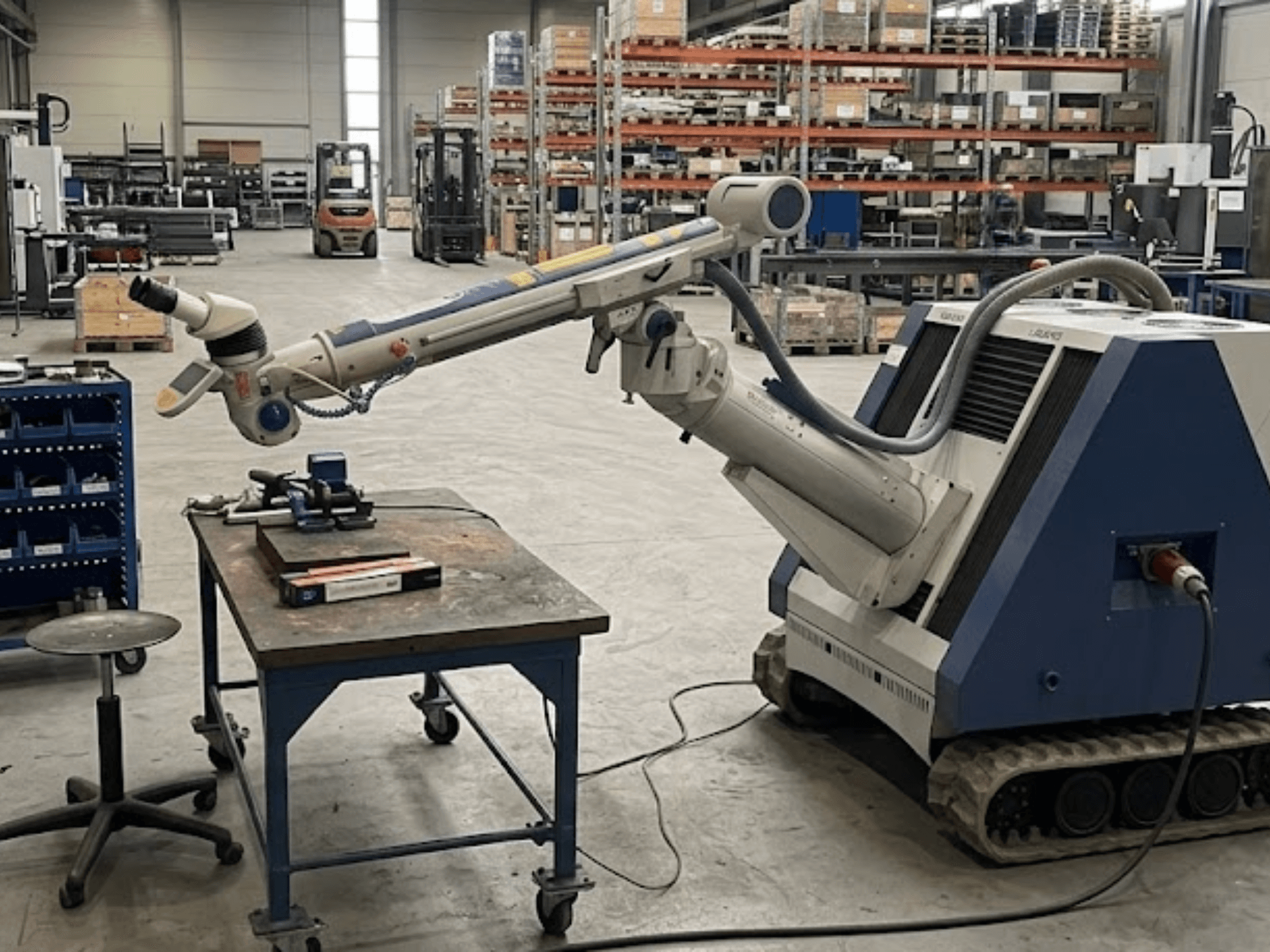 ALPHA LASER ALFlak300 M-bewerkingsmachine in een werkplaats met een robotarm; vooraanzicht dat de nauwkeurige opstelling op de werktafel laat zien.