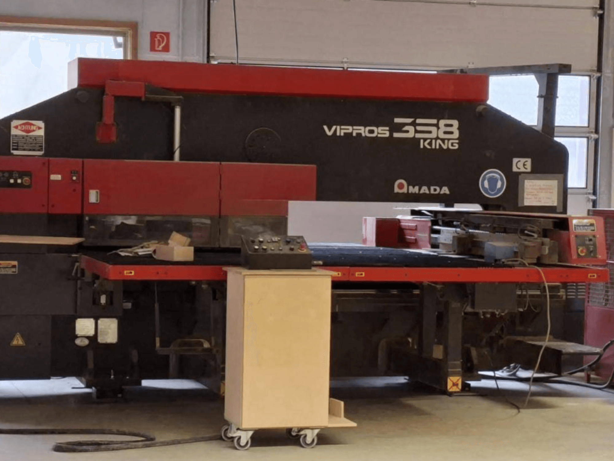 CNC-ponsmachine AMADA VIPROS 358 KING in zijaanzicht, met bedieningspaneel en opbergruimte voor gereedschap.
