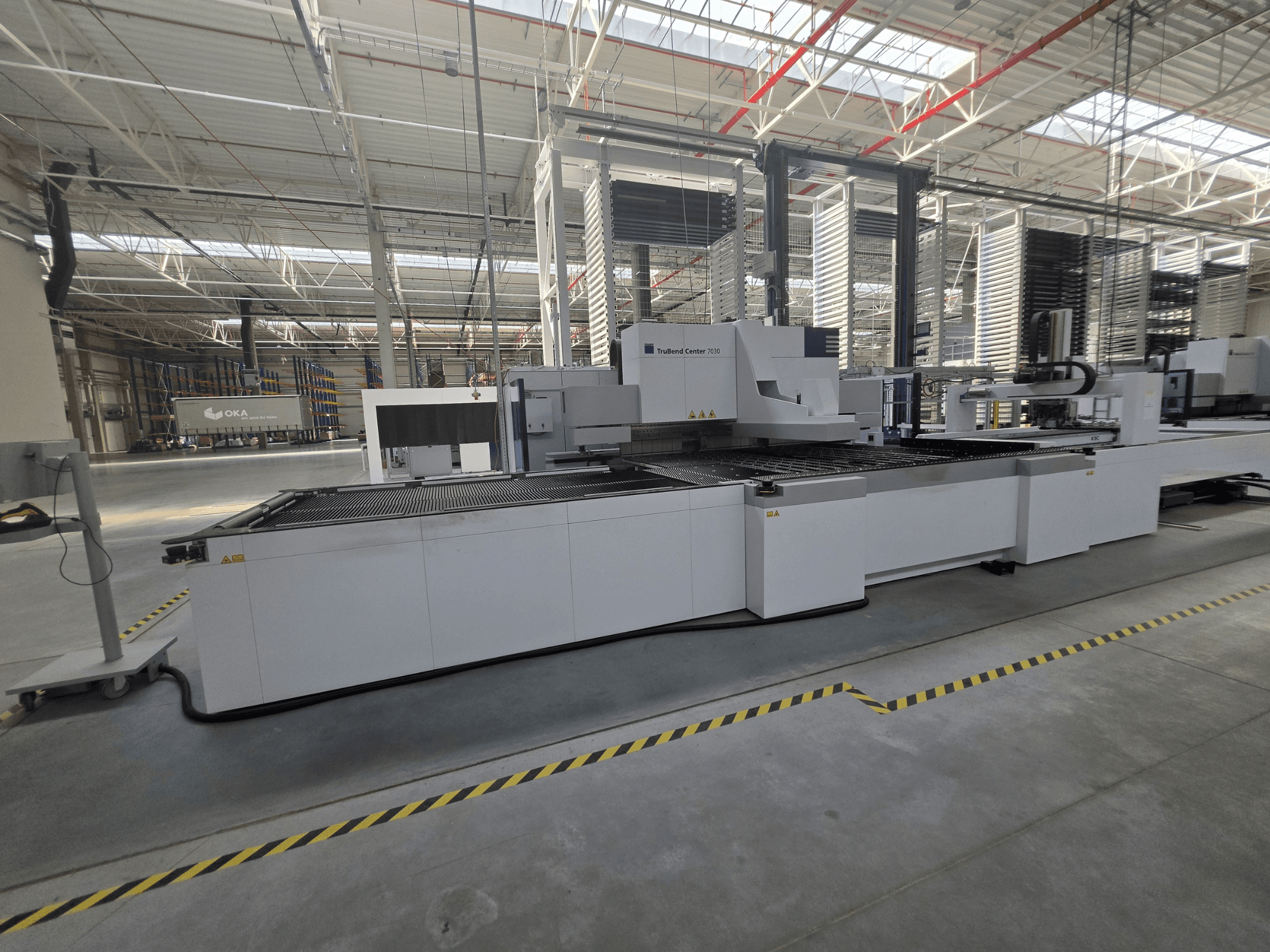 TRUMPF TruBend Center 7030 kantbank, zijaanzicht, met het werkgebied en de bedieningselementen in een ruime werkplaats.