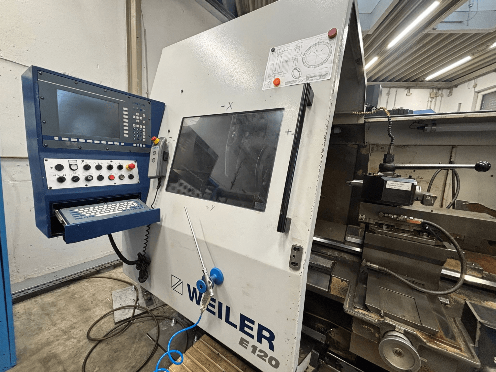 Weiler E-120 CNC machinebedieningspaneel en interface, vooraanzicht met zichtbare knoppen, beeldscherm en bedieningscomponenten.