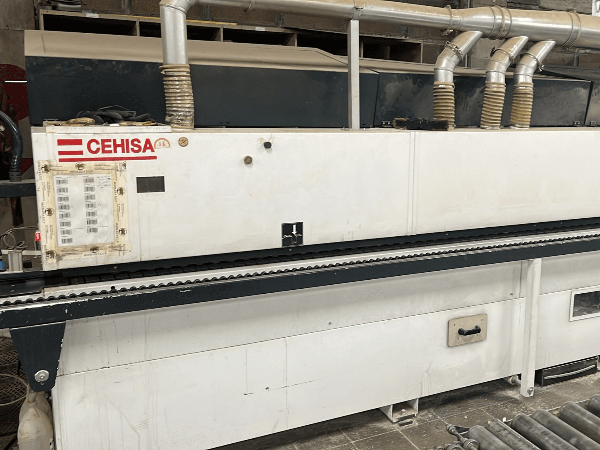 De CEHISA PRO 12 CONCEPT-kantenlijmmachine in vooraanzicht, met bedieningspaneel, stofafzuigbuizen en transportband.
