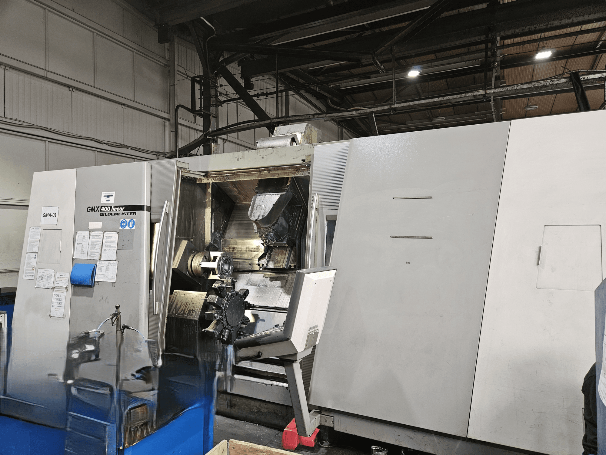 Gildemeister GMX 400 lineair draai-freescentrum in vooraanzicht, met open toegang tot het bewerkingsgebied en de gereedschappen binnenin.