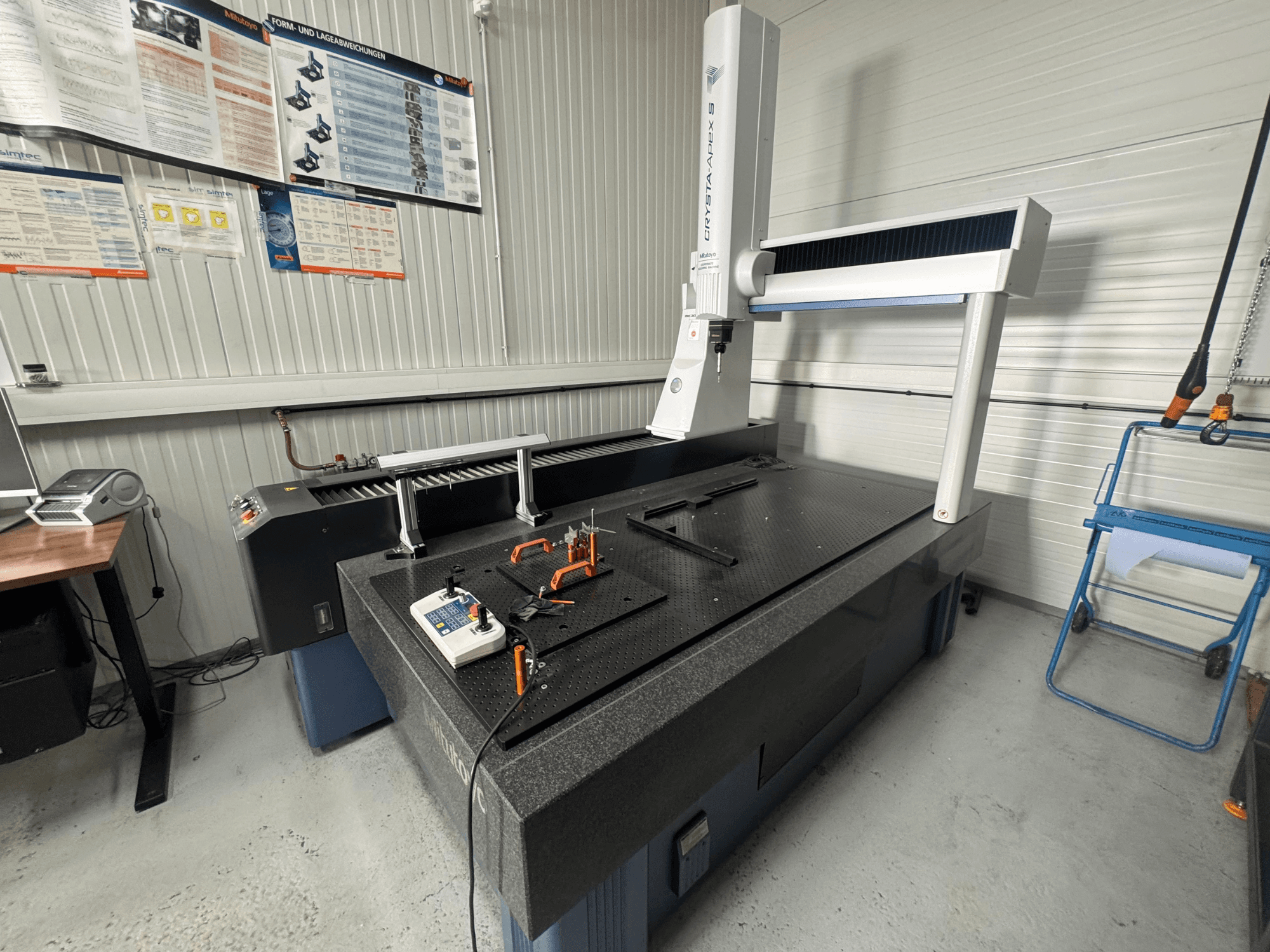 CMM coördinaten meetmachine van het merk Leitz, vooraanzicht op een zwart gestructureerd oppervlak met meetgereedschap.