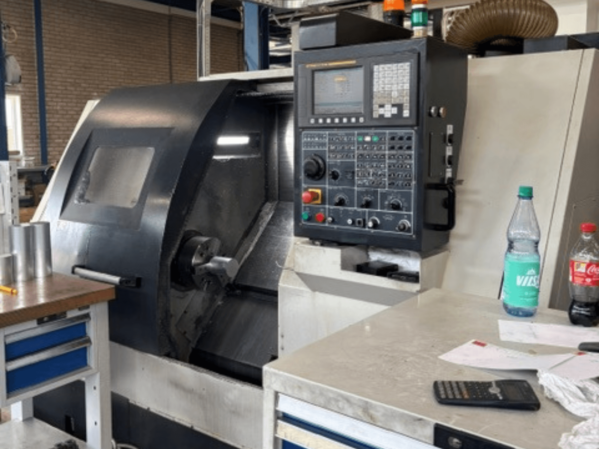 Leadwell T-7 horizontale draaimachine, vooraanzicht, met bedieningspaneel, werkstuk op de gereedschapsteun en details van de werkruimte zichtbaar.