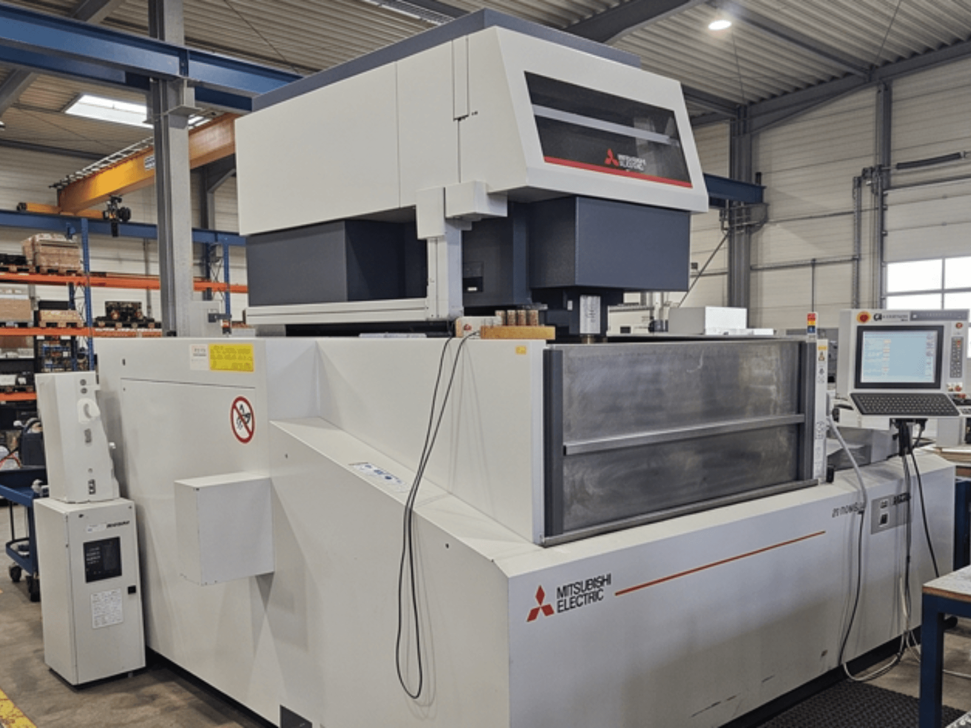 Mitsubishi MV-4800 draadvonkmachine, vooraanzicht, met het bedieningspaneel en het werkgebied in een fabrieksomgeving.