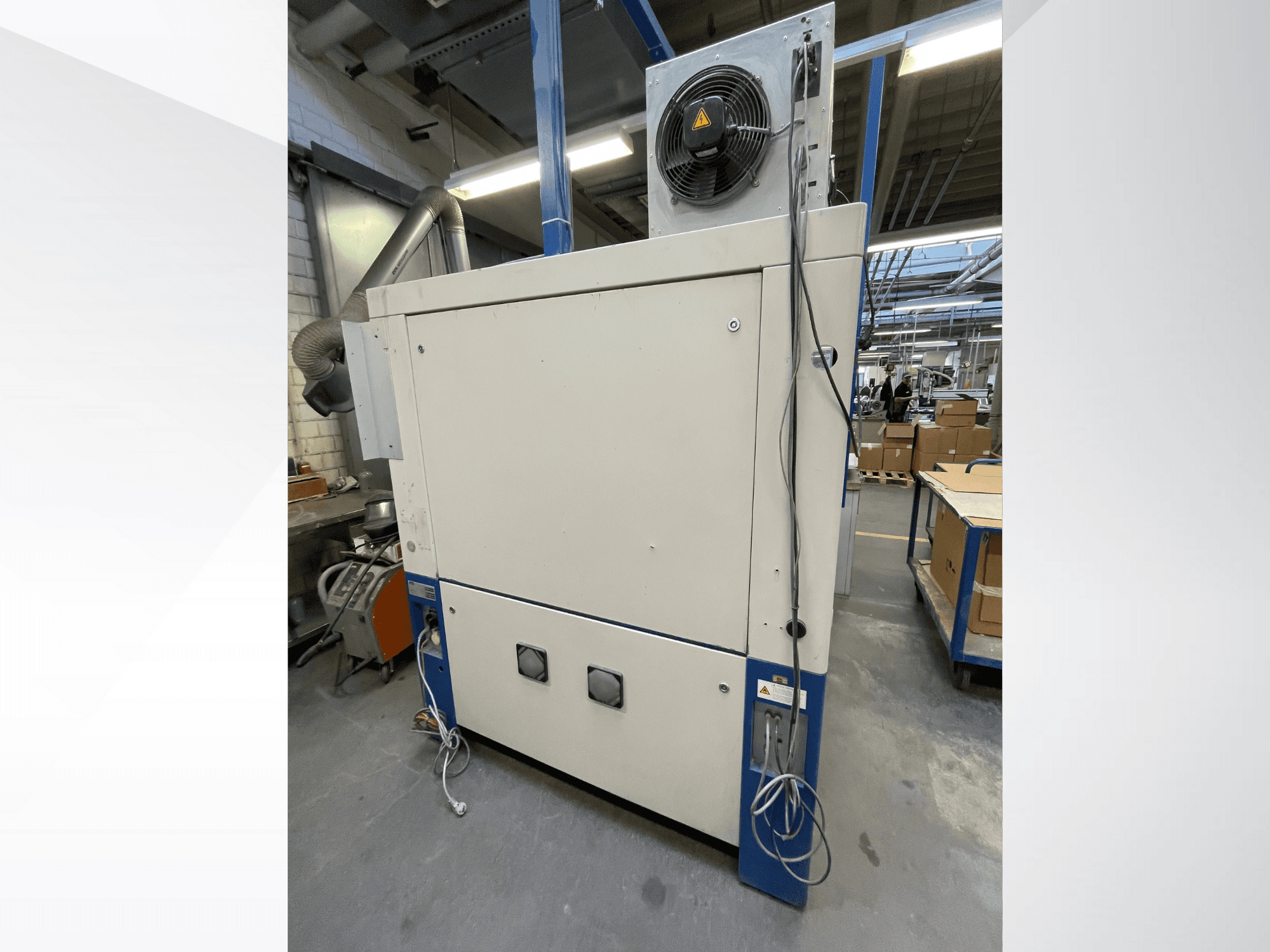 Industriële droogmachine met ventilator, zijaanzicht; voorzien van ventilatie en meerdere elektrische aansluitingen. Merk/model niet zichtbaar.